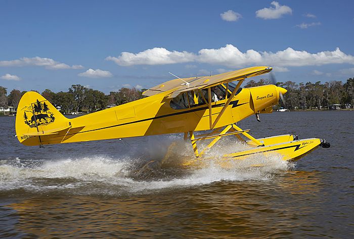 AOPA's 2019 Piper Super Cub Sweepstake aircraft on Lake Pierce with it's brand new Wipaire 2100 amphib floats. with aircraft paint scheme by Craig Barnett